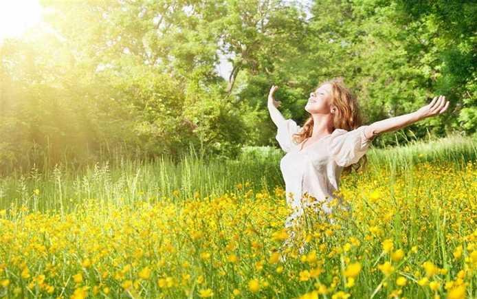 person is outside feeling happy because of having good finances