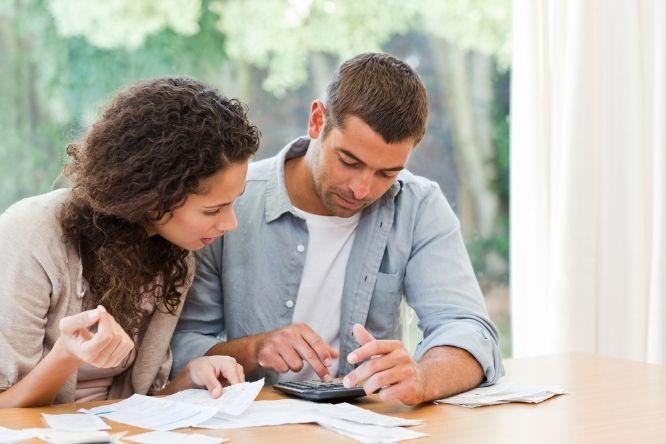 Young couple calculating their domestic bills